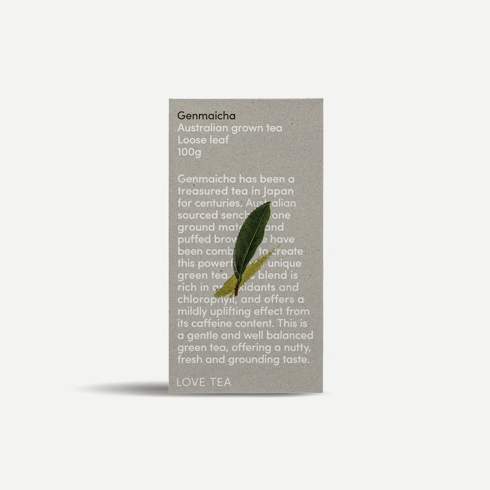 Tea packaging with text and a leaf on a light gray background